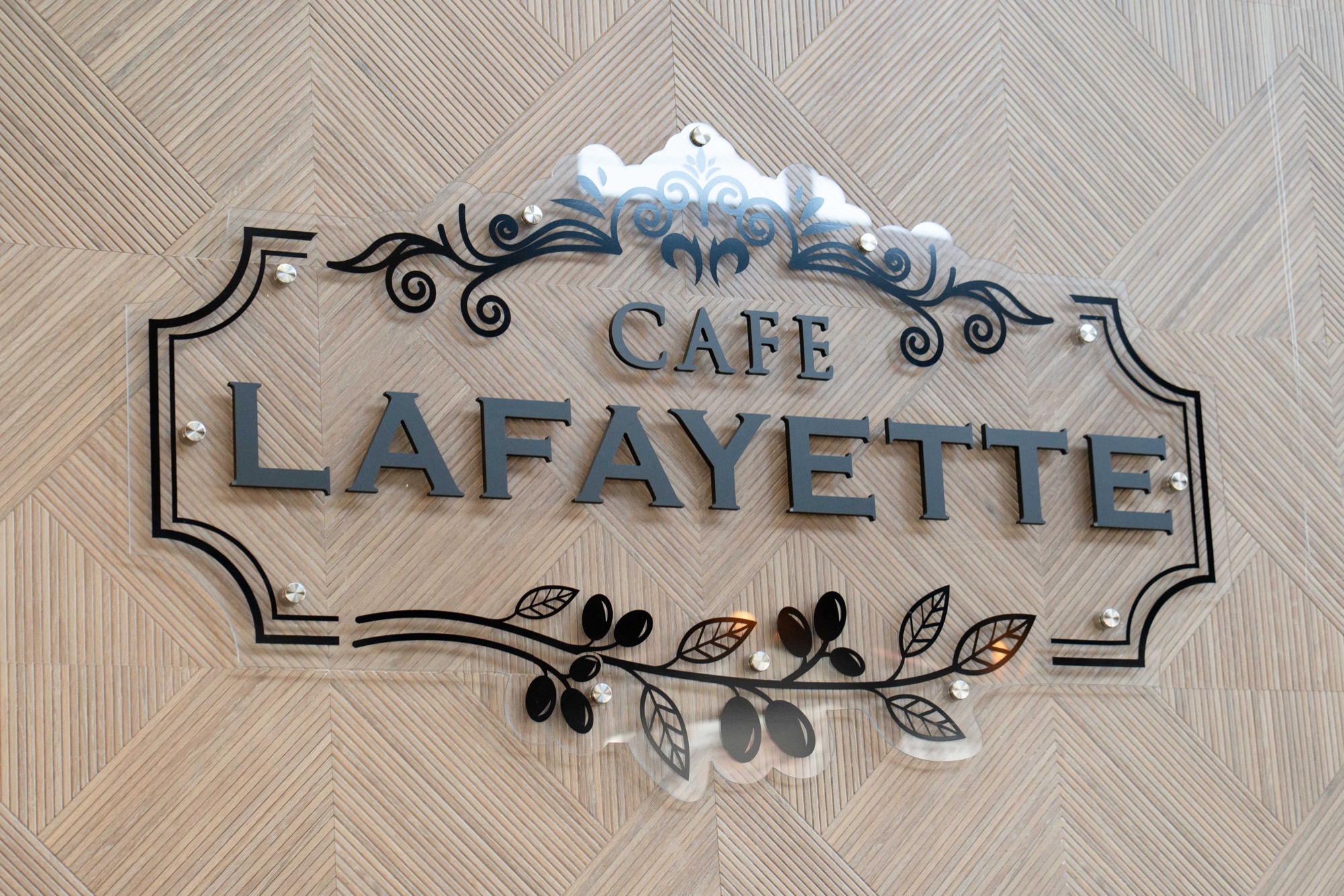 Cafe Lafayette wall sign on herringbone wood
