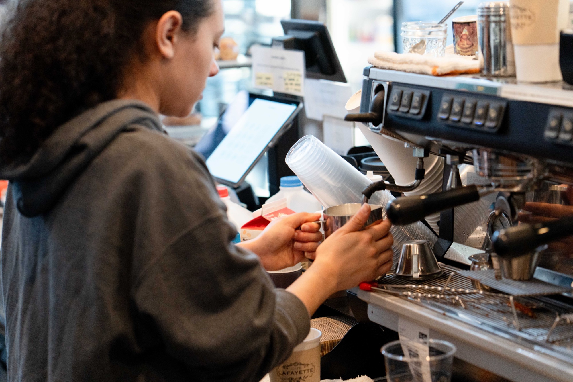 Barista crafting drinks behind the espresso bar
